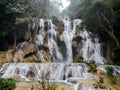 Jangle landscape with amazing turquoise water of Kuang Si cascade waterfall at deep tropical rain forest. Luang Prabang, Laos Royalty Free Stock Photo