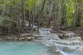 Jangle landscape with flowing turquoise water of Erawan cascade waterfall Royalty Free Stock Photo