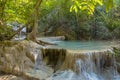 Jangle landscape with flowing turquoise water of Erawan cascade waterfall Royalty Free Stock Photo