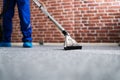 Janitor Cleaning Carpet With Vacuum Cleaner Royalty Free Stock Photo