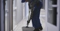 Janitor cleaning a corridor Royalty Free Stock Photo