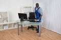 Janitor Cleaning Desk With Cloth Royalty Free Stock Photo