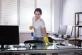 Janitor Cleaning Desk With Rag Royalty Free Stock Photo