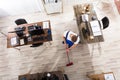 Janitor Cleaning Floor With Broom In Office Royalty Free Stock Photo