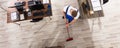 Janitor Cleaning Floor With Broom In Office Royalty Free Stock Photo