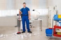 Janitor Cleaning Floor With Broom In Office Royalty Free Stock Photo