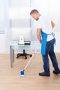 Janitor cleaning the floor in an office building Royalty Free Stock Photo