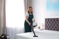 Janitor cleaning mattress with professional equipment