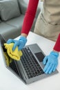 Janitor cleaning the office, Clean the notebook with a rag, wear gloves and wipe with a towel, Wear rubber gloves when working