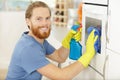 janitor cleaning oven in kitchen Royalty Free Stock Photo