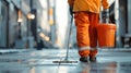 A janitor cleaning a public space, highlighting the importance of sanitation workers