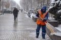 Janitor is cleaning snow in the city after snowfall