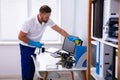 Janitor cleaning white desk in office Royalty Free Stock Photo