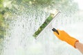 Janitor cleaning window with squeegee indoors Royalty Free Stock Photo