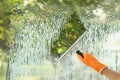 Janitor cleaning window with squeegee indoors Royalty Free Stock Photo