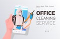 Janitor in hazmat suit cleaner in mask smartphone screen self isolation office cleaning service concept Royalty Free Stock Photo