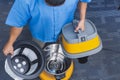 A janitor removes the inner dust filter bag from a commercial grade vacuum cleaner. Overhead shot Royalty Free Stock Photo