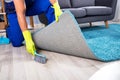 Janitor Sweeping Dirt Under The Carpet Royalty Free Stock Photo