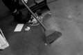 Janitor sweeping garbage broom dustpan inside floor