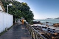 Janitor sweeping a wooden walkay - Balneario Camboriu, Santa Catarina, Brazil