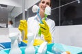 Janitor or charlady with her work tools looking at camera in toilet Royalty Free Stock Photo