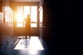 Janitor woman sillouette mopping floor in hallway office building