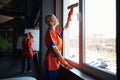 Janitorial staff washing the whiteboard and windows Royalty Free Stock Photo