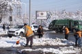 Janitors are cleaning snow on street after snowstorm. Manual work. Ice storm.