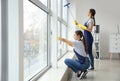 Janitors washing window in office