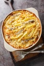 Janssons frestelse casserole consists of potatoes and anchovies which are layered with onions and then doused in cream closeup on