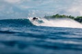 January 4, 2023. Bali, Indonesia. Man in ocean during surfing. Surfer ride on surfboard in blue wave Royalty Free Stock Photo