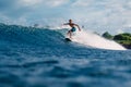 January 4, 2023. Bali, Indonesia. Man in ocean during surfing. Surfer ride on surfboard in fun wave