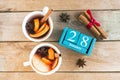 January 28. Blue cube calendar with month and date and cups with mulled wine