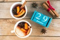 January 29. Blue cube calendar with month and date and cups with mulled wine