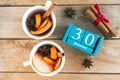 January 30. Blue cube calendar with month and date and cups with mulled wine