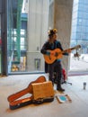 Male street artist playing guitar during a climate change protest rally as a call to action