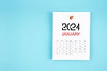 January 2024 calendar page with push pin on blue background Royalty Free Stock Photo