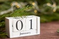 January 1 on the calendar on a wooden background next to the Christmas tree.The concept of the beginning of the new year Royalty Free Stock Photo