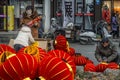 Small vendor who is assembling red lanterns