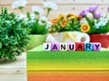 January. Colorful cube letters on sticky note block.