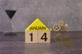January 14 displayed wooden letter blocks on white background with space for print. Concept for calendar, reminder, date