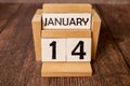 January 14 displayed wooden letter blocks on white background with space for print. Concept for calendar, reminder, date