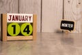 January 14 displayed wooden letter blocks on white background with space for print. Concept for calendar, reminder, date