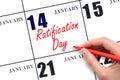 January 14. Hand writing text Ratification Day on calendar date. Save the date.