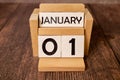 1 January inscription on wooden calendar on background of trendy 2024 colors of yellow and gray. Royalty Free Stock Photo