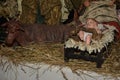 Christmas nativity scene - Jesus Christ, Mary and Joseph. Wooden figurines, donkey in the background