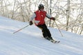 Elderly man skiing down ski slope Royalty Free Stock Photo