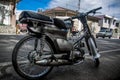 Dramatic image of old Honda motorbike parked on the street.