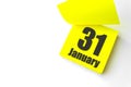 January 31st . Day 31 of month, Calendar date. Close-Up Blank Yellow paper reminder sticky note on White Background. Winter month Royalty Free Stock Photo