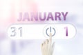 January 1st . Day 1 of month, Calendar date.Hand finger switches pointing calendar date on sunlight office background. Winter